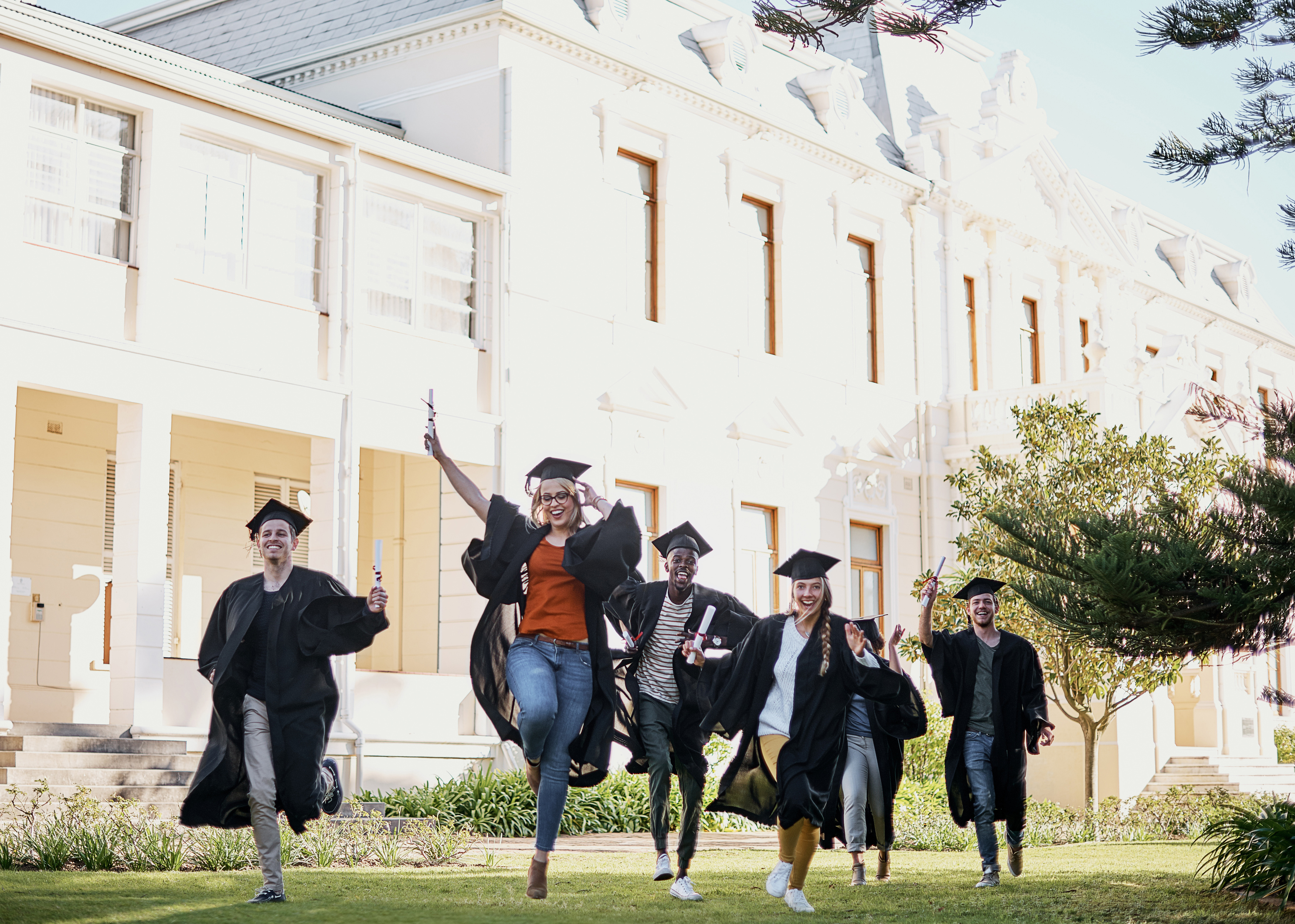 running-straight-towards-their-dreams-shot-group-students-running-together-row-graduation-day
